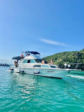 Miss Bardot anchored in green waters